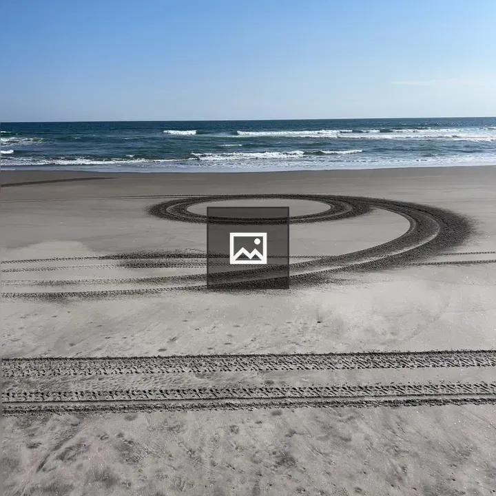 Aerial View of Beach with Tire Tracks