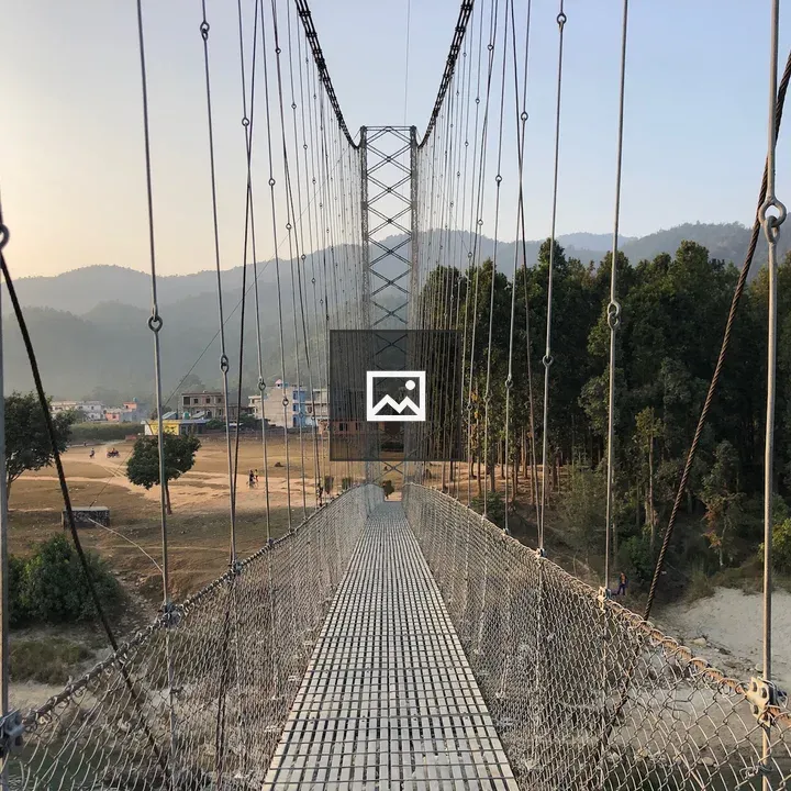 Suspension bridge over Nepal landscape