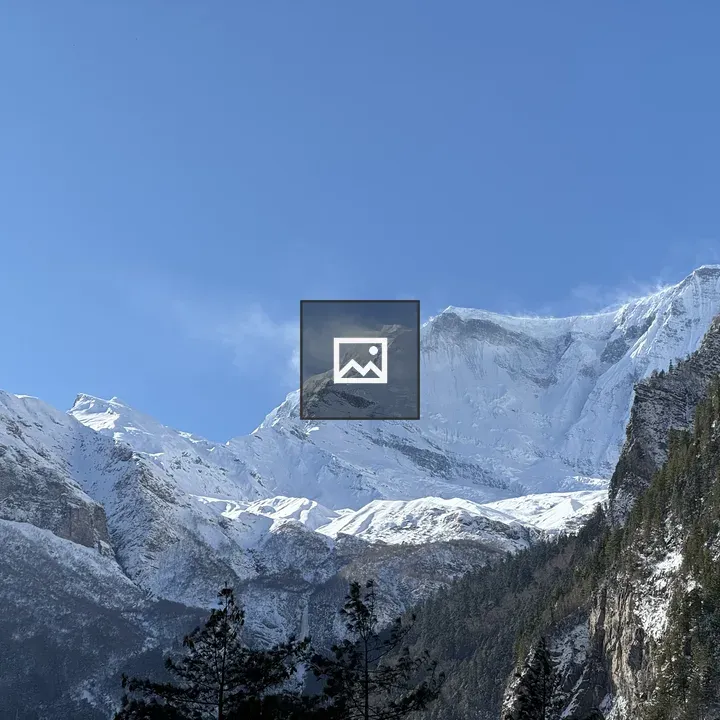 Snowy mountain peaks with pines