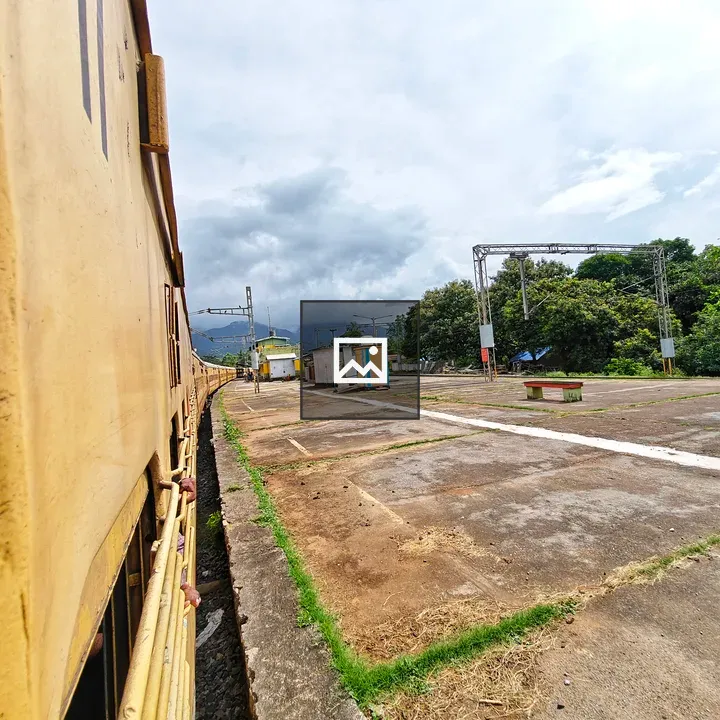 Train at the Station with Waiting Passengers