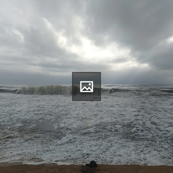 Rolling surf on cloudy beach