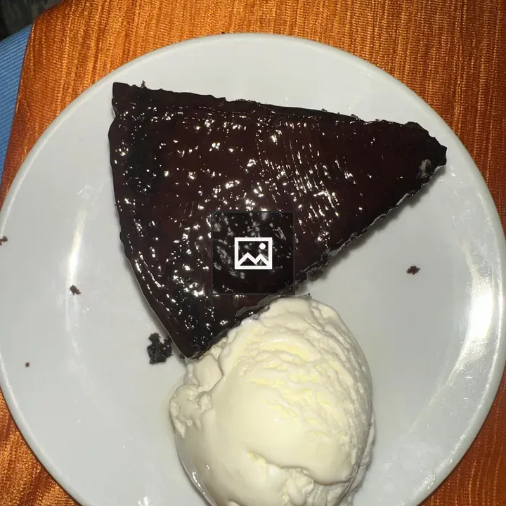 Slice of chocolate cake with vanilla ice cream