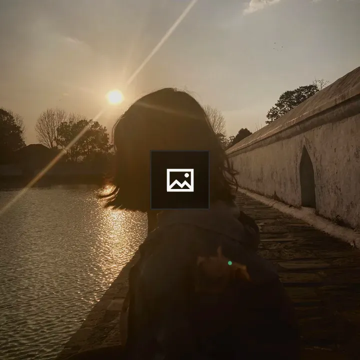 Silhouette by Water at Sunset