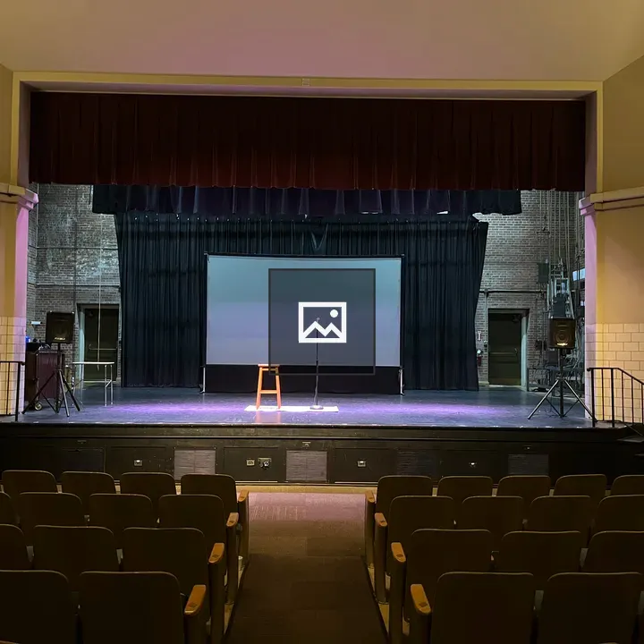 Stage with Empty Chairs and Microphone