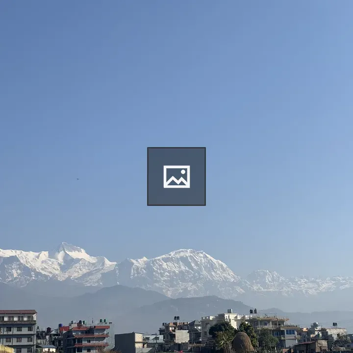 Cityscape with Snowy Mountains