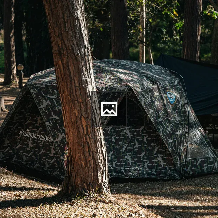 Camouflage Tent in Pine Forest