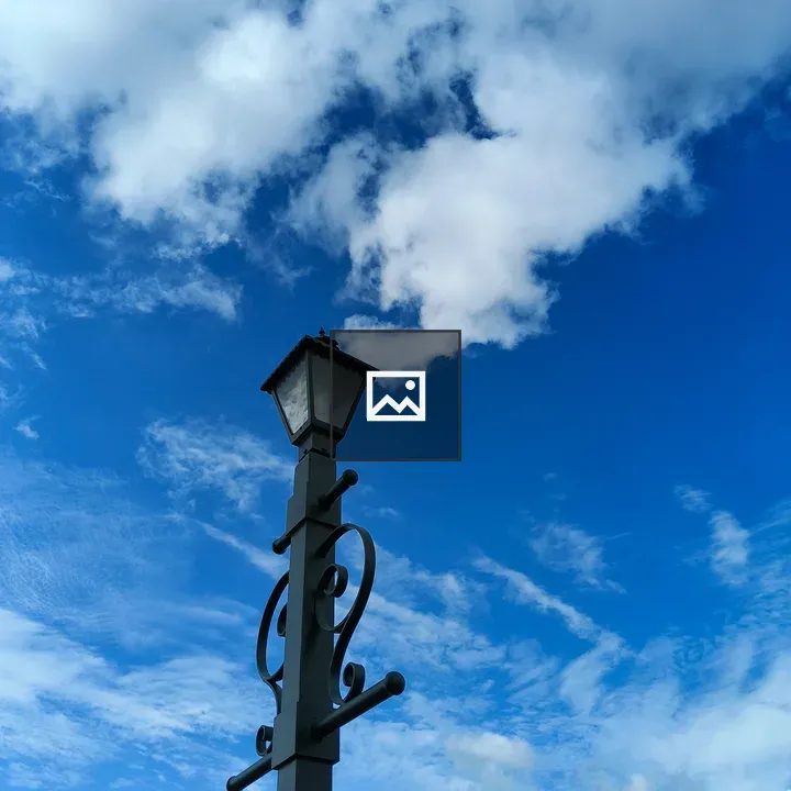 Vintage lamp against cloudy sky