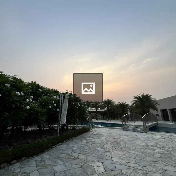 Paved patio with pool and bridge