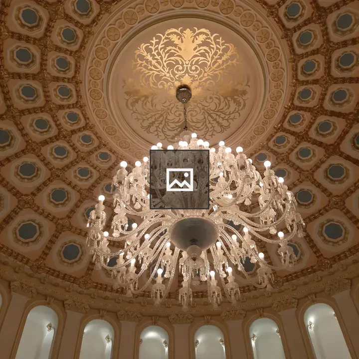 Grand chandelier in ornate ceiling