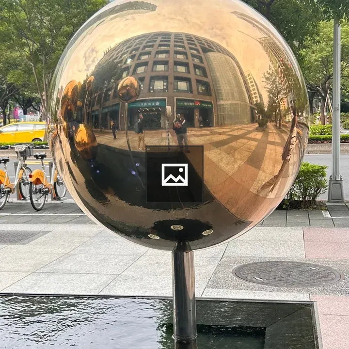 Reflective golden sphere on pole
