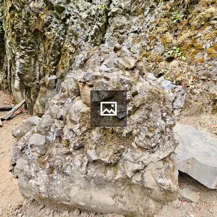 Jagged rock over mossy cliff