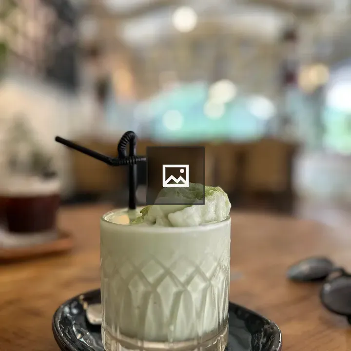 Creamy green drink in ornate glass