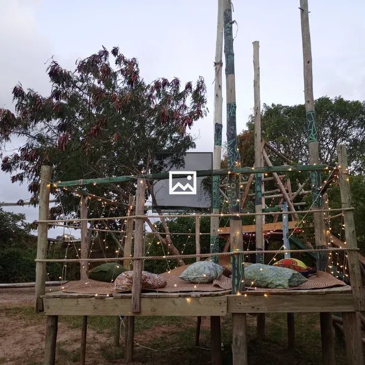 Wooden tree-house platform with fairy lights