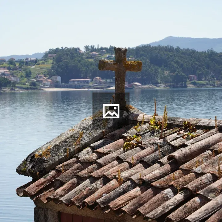 Rustic stone roof with cross