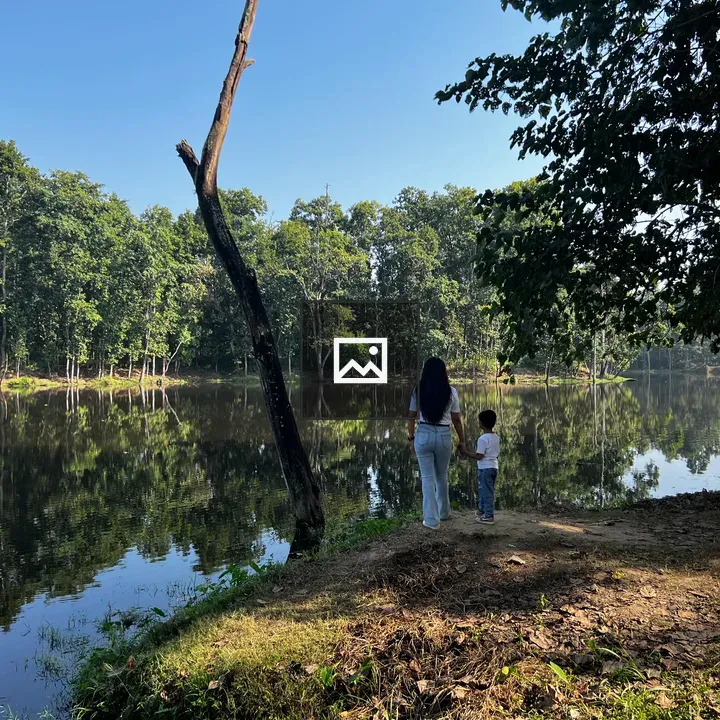 Boy and woman by lake shore