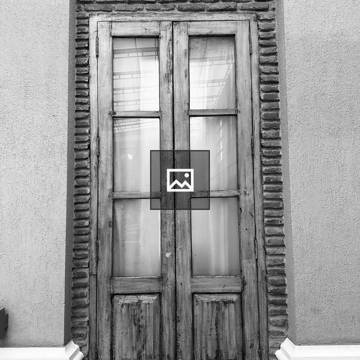 Old wooden door with brick surround