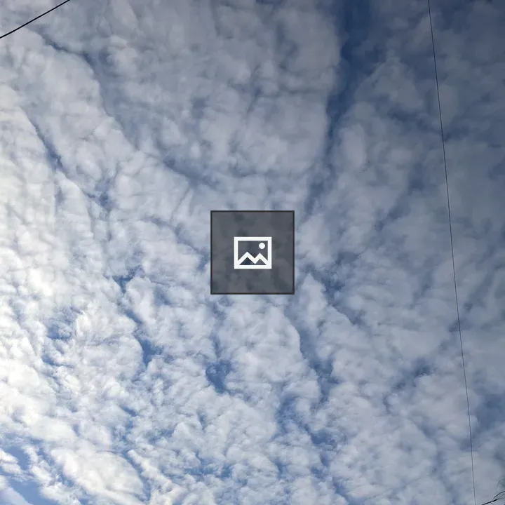 A cloudy sky over power lines