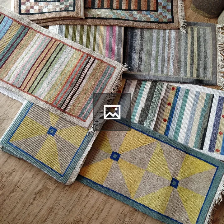 Colorful woven rugs on wooden floor