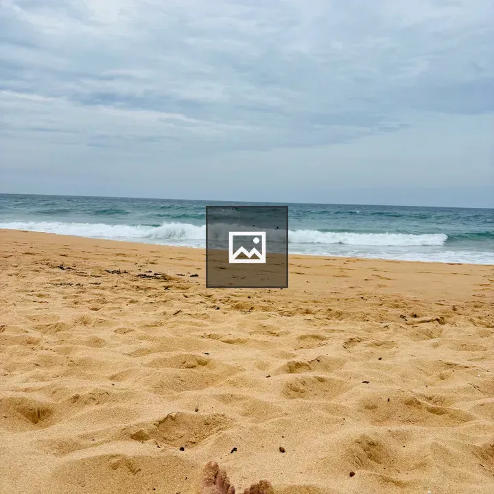 Feet resting on sandy beach