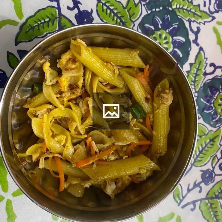 Pasta with vegetables in metal bowl