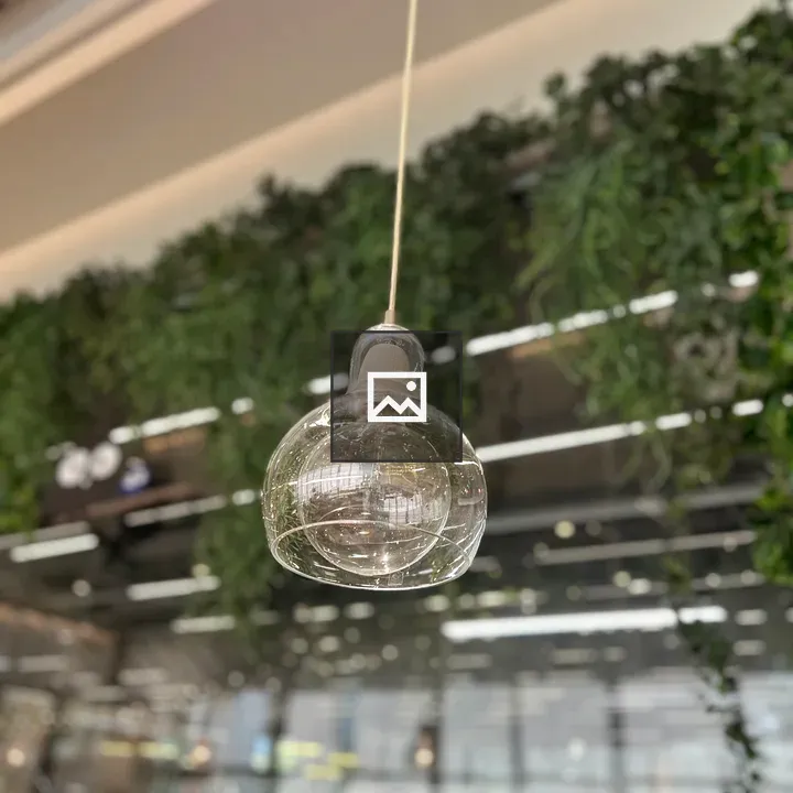 Glass pendant light with greenery