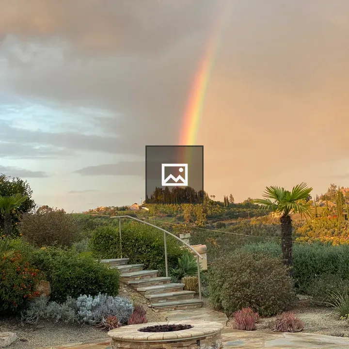 Backyard Garden with Stone Path and Rainbow