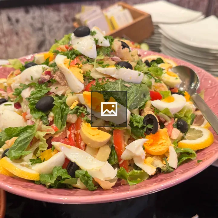 Salad with Eggs and Olives on Pink Platter