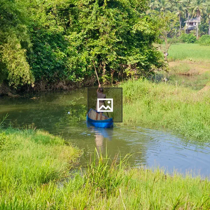 Man paddling small fiber boat