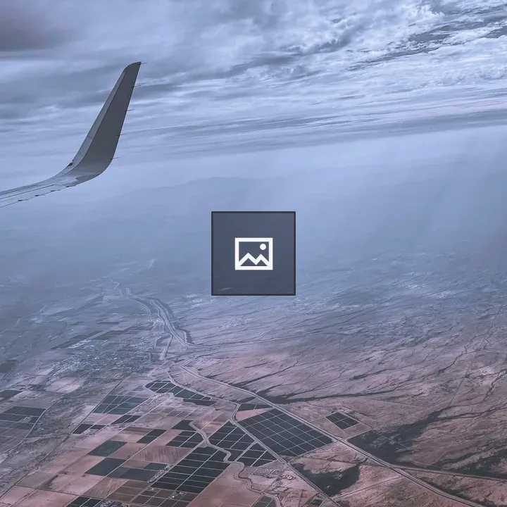 Airplane Wing View Over Patchwork Fields