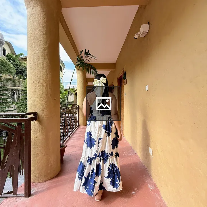 Woman with White Hair Bow in Corridor