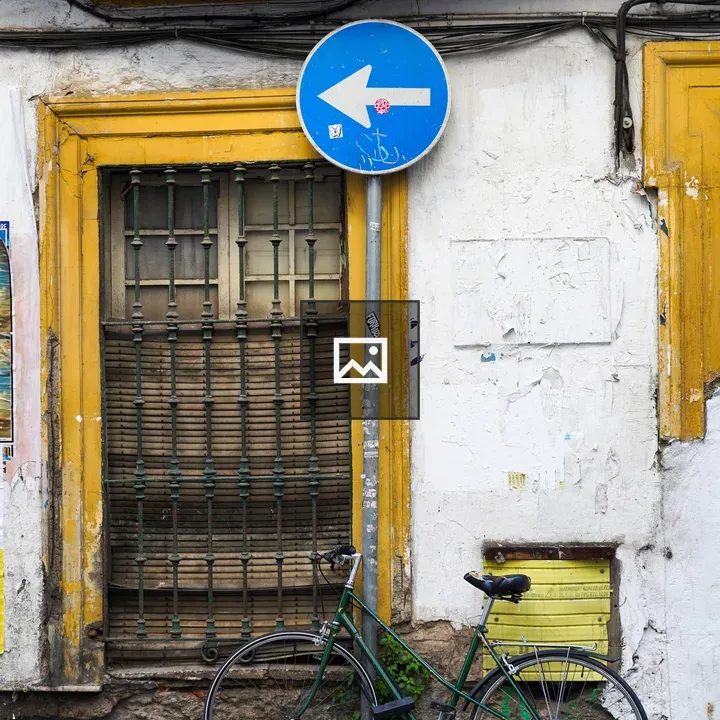 Green bicycle in front of old building