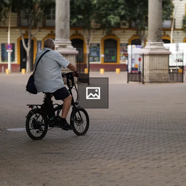 Person on bicycle with bag