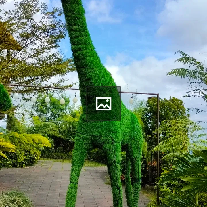 Giraffe-shaped structure with foliage