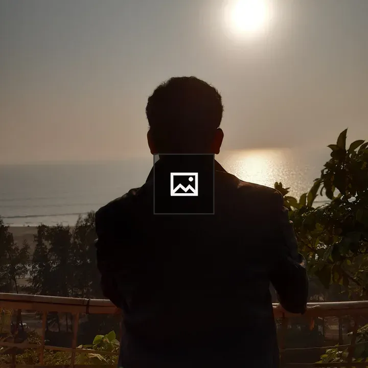 Person by Sunlit Ocean