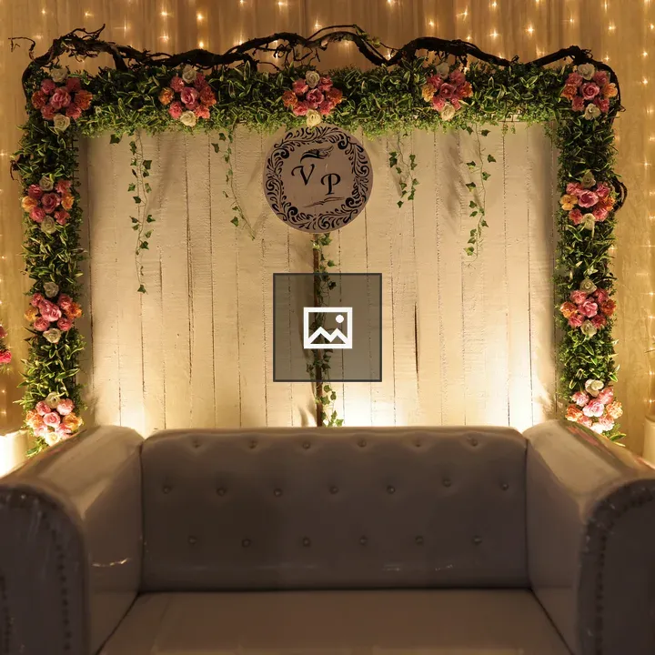 A decorated wedding stage with a sofa