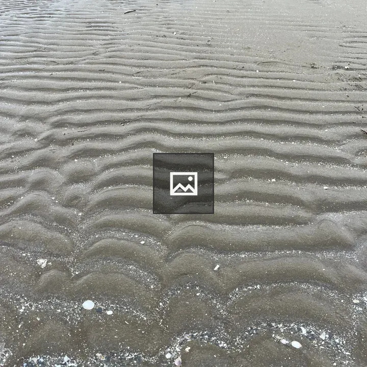 Wet sandy beach with ripples