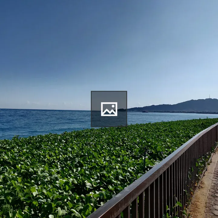 Coastal view with railing and greenery