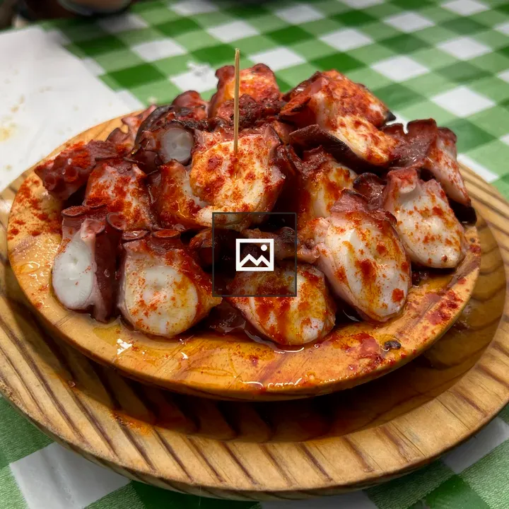 Pulpo a feira on wood dish