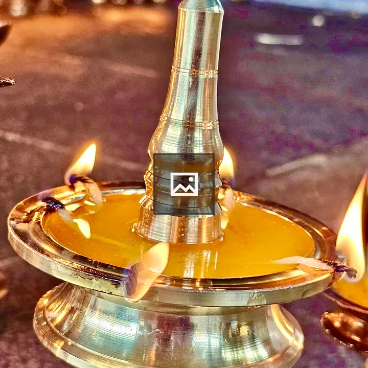 Traditional brass lamp in use