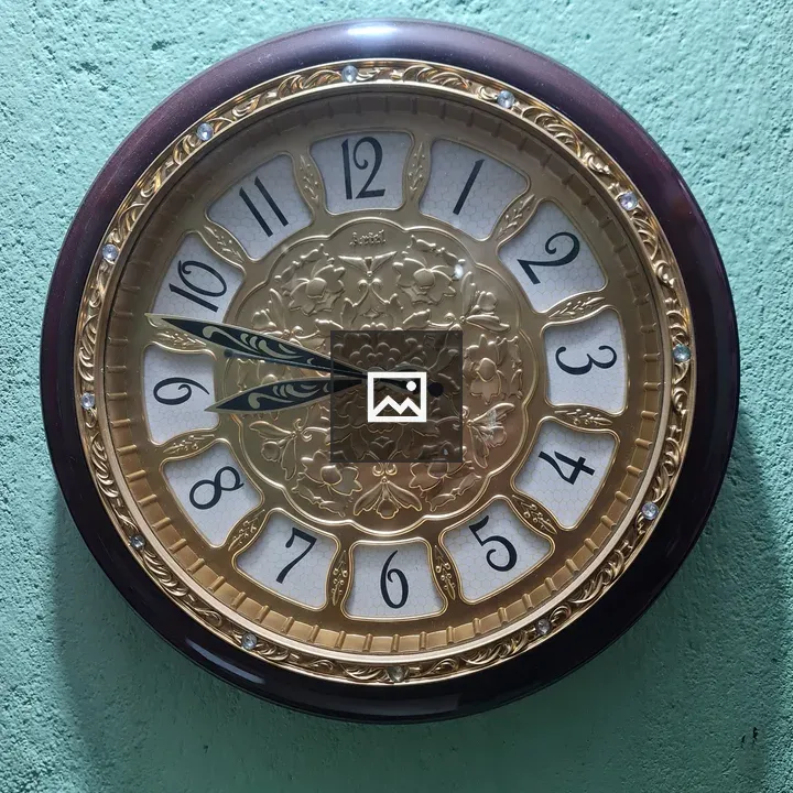 Circle-shaped watch on green wall