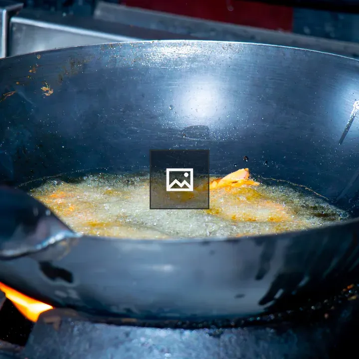 Wok with hot oil frying