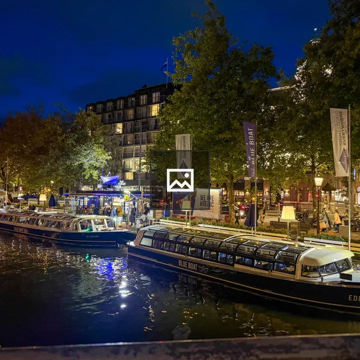 Illuminated canal boats at night