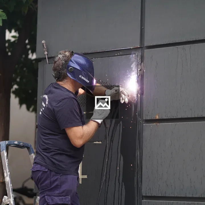 Worker welding outdoors