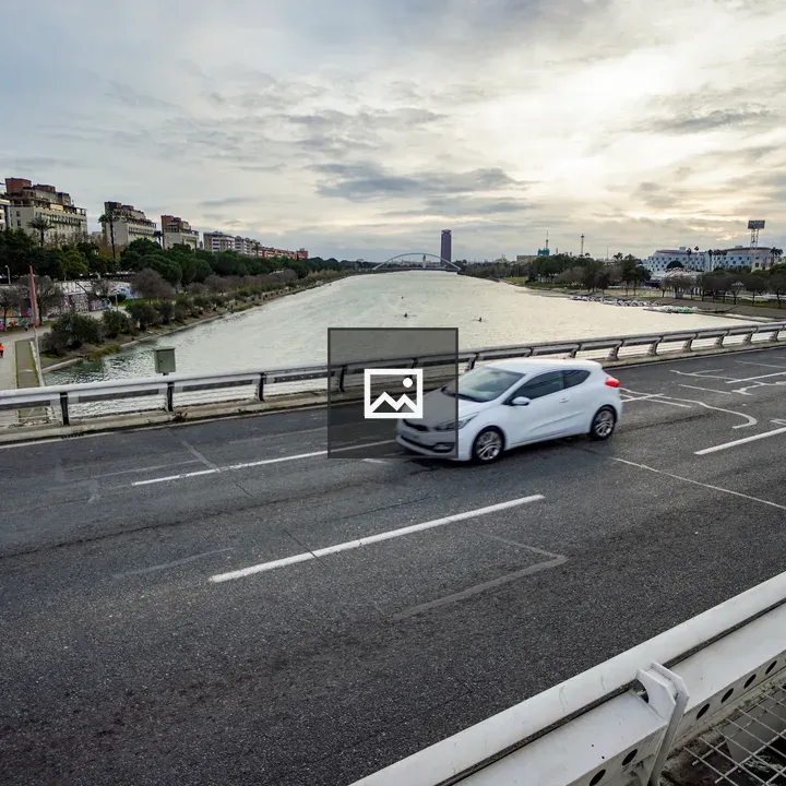 White car on bridge over Guadalquivir