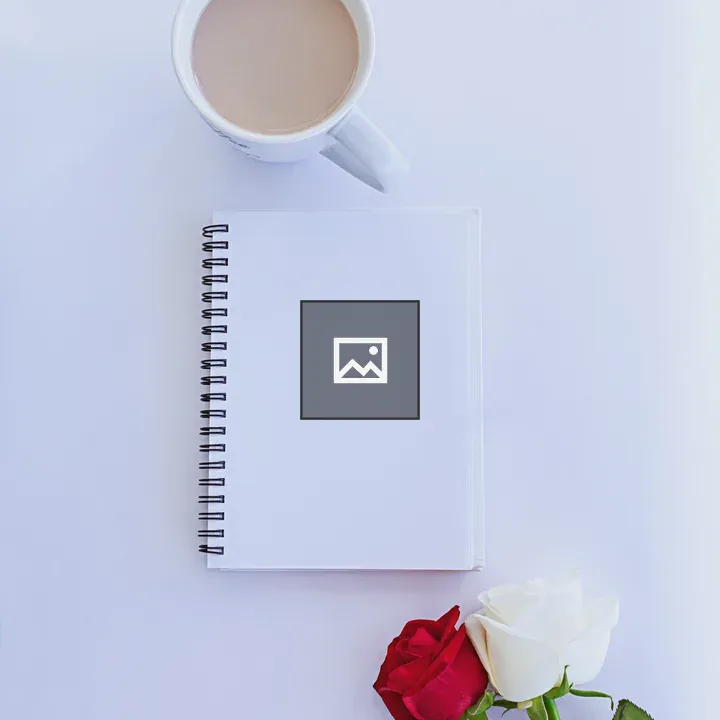 Coffee cup with notebook and roses