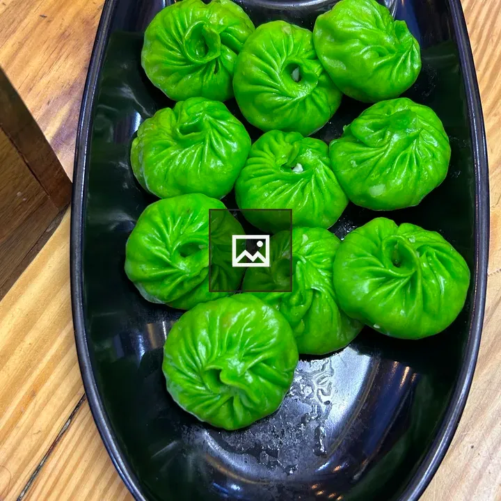 Green Dumplings on Black Plate