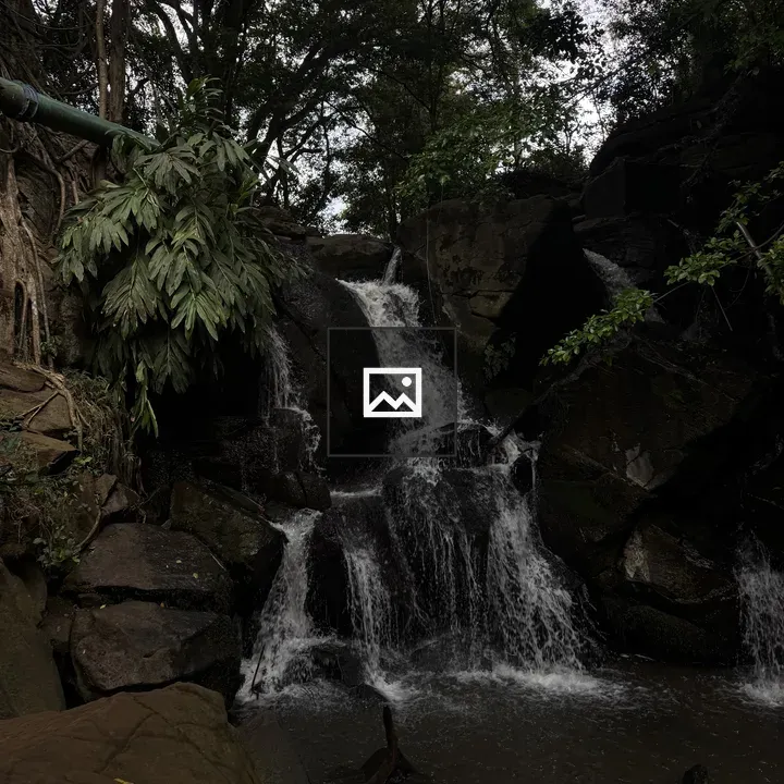 Waterfall Cascades Over Mossy Rocks