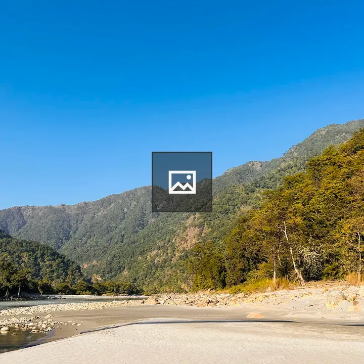 Riverbank with green mountains