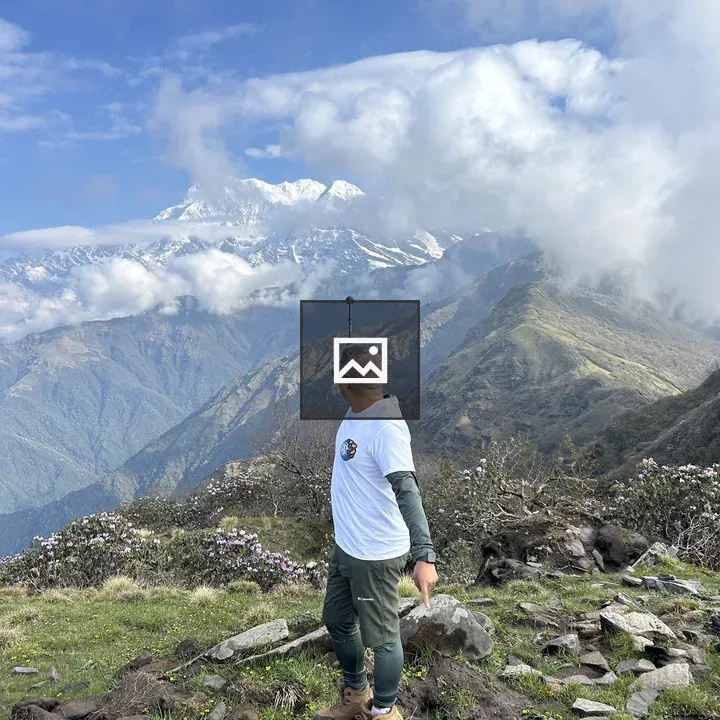Person on rock with mountain view