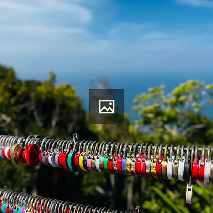 Colorful padlocks on railing